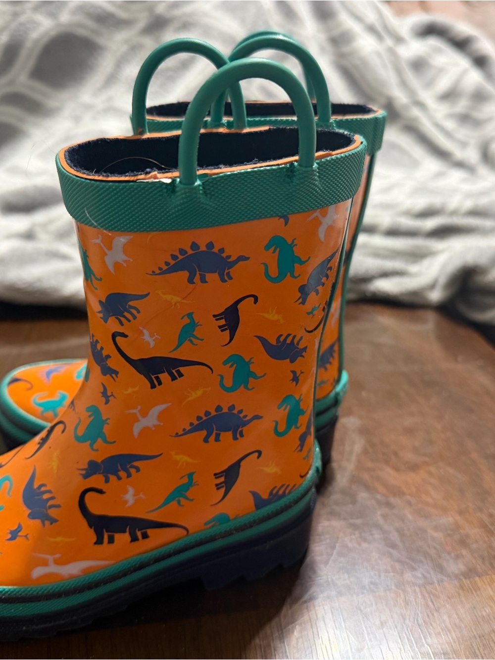 Orange Kids Rain Boots with Teal Trim and Playful Dinosaur Print